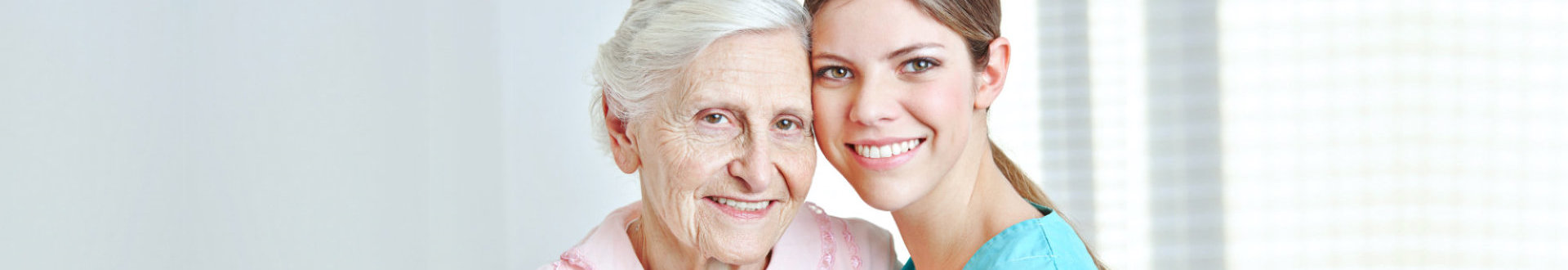 senior woman smiling together with caregiver